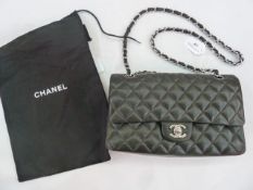Chanel vintage quilted bag in black, turn lock fastening with Chanel logo, burgundy lining printed