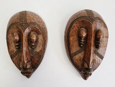 Pair of African masks marked 'Loute'