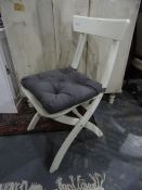 Two modern folding white chairs