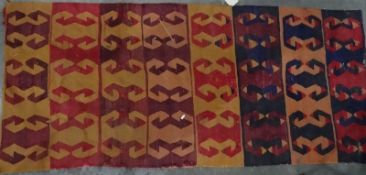 Eastern-style rug with hooked motif, in reds, oranges and blues, 180cm x 80cm together with one