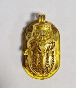 Yellow gold-coloured Egyptian pendant in the form of rounded oblong tablet embossed hieroglyphics,