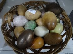 Collection of onyx and carved wooden eggs together with an oak carved hanging wall cupboard