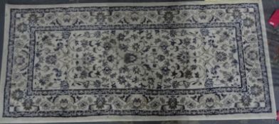 Cream ground modern rug, 175cm x 80cm and one further, red ground, 177cm x 80cm (2)