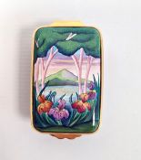 Moorcroft enamel patch box, rectangular and decorated with irises in lakeside landscape,