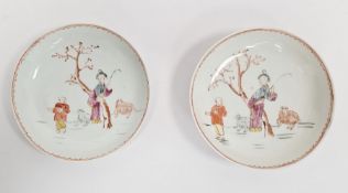 Pair antique Chinese porcelain saucers, each painted with two figures beside tree and sheep, 13cm