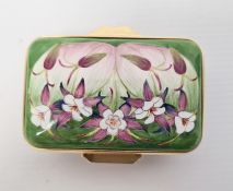 Moorcroft enamel patch box, rectangular, green ground and floral decorated, initialled 'FW' to base,