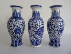 Near pair of Chinese porcelain baluster vases with underglaze blue decoration of flowerheads, on a