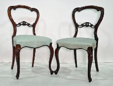Set of four Victorian rosewood dining chairs with carved top rails, carved and pierced bar backs,