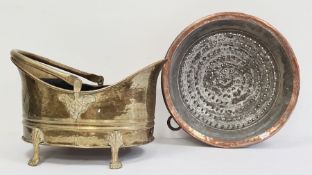Two 19th century brass hand-beaten, repousse swing-handled coal bucket on four splayed supports