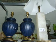 Pair of black ovoid-shaped ceramic table lamps, a large square alabaster table lamp with shade,