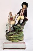 Early 19th century Staffordshire pearlware group of milkmaid and companion, on grassy mound base and