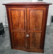 19th century mahogany linen press, the moulded cornice above two panelled doors enclosing various