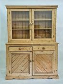 Late 19th century pine dresser with moulded pediment above two glazed doors enclosing shelves, faced