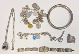 Hollow silver bangle, a silver charm bracelet, various charms, etc