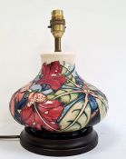 Moorcroft pottery table lamp, squat baluster shape and having tube-lined hibiscus decoration,