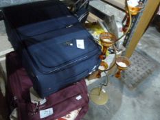 Two suitcases, assorted textiles and a floor-standing candle holder