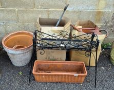 A quantity of terracotta pots, watering cans and pot stand