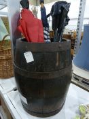 Half-barrel, two umbrellas, a back scratcher, a picnic seat, a picnic basket, a brass table lamp