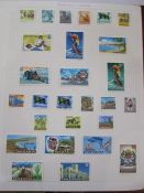 Album of Tanganyiki stamps, giraffe issues 14 values to £1, GV portrait set 1927 to 31, a range of