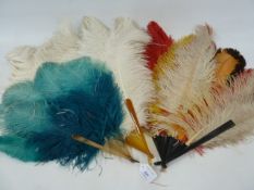 A turquoise and bakelite ostrich feather fan, a white ostrich feather fan and another multi coloured