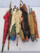 Various vintage parasols, in varying conditions, including one trimmed with ostrich feathers and