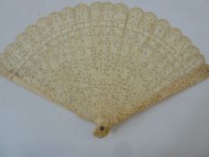 A 19th century Chinese export ivory brise fan, the guards decorated with scenes of figures, the