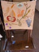 A small folding beach/ picnic vintage chair, with an embroidered linen back