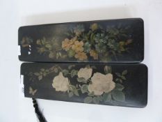 Two oriental lacquered glove boxes, black lacquer with red interiors, floral decorated 30 cm x 9.5cm