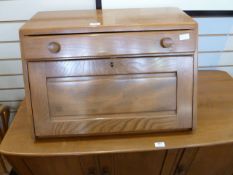 Ercol elm table top bureau with fall-front, single drawer above with circular handles, curved bar