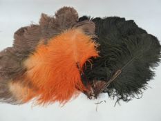 A black ostrich feather and tortoiseshell fan and an orange and brown ostrich feather fan (2)