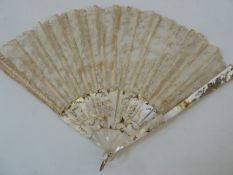 A 19th century mother of pearl and lace fan, one side the mother of pearl floral decorated with gilt