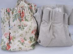 Two pairs of short linen French pleat headings in pale green with white spots and floral curtains