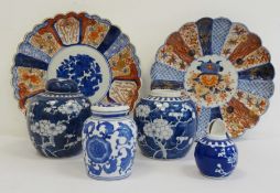 Two Japanese Imari circular dishes and four blue and white Oriental ginger jars (one missing lid and