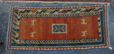 Pink ground rug with central rectangular motif, animal decoration, in pinks, whites and blues, 193cm