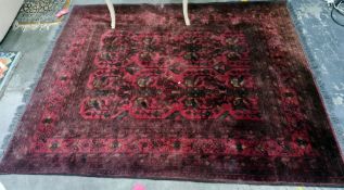 Red ground rug with foliate design, stepped border, 190cm x 135cm approx