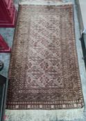 Eastern rug, the central field with hooked diamond medallions, stepped border, 185cm x 100cm approx