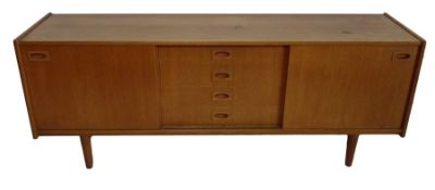 20th century teak sideboard with two sliding doors and four central drawers, raised on turned