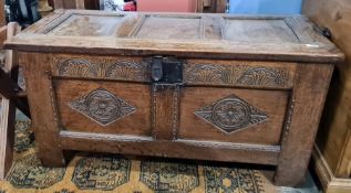 Oak coffer with carved channel decoration to the top, carved front and stile supports
