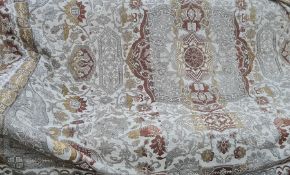 A textile throw, beige ground with central medallion in brown and yellow with decoration of stags
