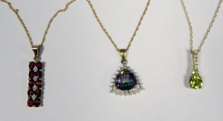 9ct gold pendant on chain set with trillion-shaped multi-coloured gem, a 9ct gold pendant set with