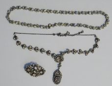 Silver and paste set necklace of stylised leaf pairs and set with two oval facet cut pendants, paste