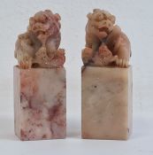 Pair of Chinese carved hardstone models of dogs of fo, on square bases, 6.5cm high (2)