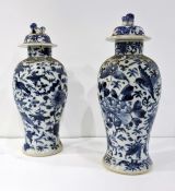 A pair of Chinese lidded baluster vases, full character mark for Kangxi (both damaged)(23cm)