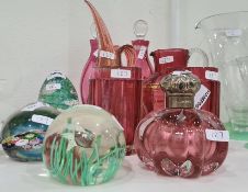 Four paperweights, a pair of cranberry small decanters, a Murano cranberry and gold jug with pointed