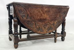 Late 19th century oak gateleg table, the top with carved decoration, on turned and block legs,