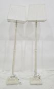 Pair of cream painted and fluted standard lamps on square bases with white pleated shades (2)