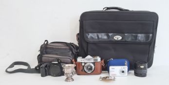 Paxette Reflex camera, a Minolta camera and lens in carry case, a Vivitar digital camera in blue