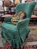 Armchair in pale green loose covers