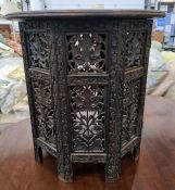 Eastern circular centre table with carved and inlaid top, on folding carved and pierced base, 45cm