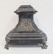 Ebonised stand with metal relief mounts, on scroll shaped feet, 27cm high